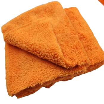 Two bright orange folded towels stacked on top of each other, showing soft terry fabric. - bravaro