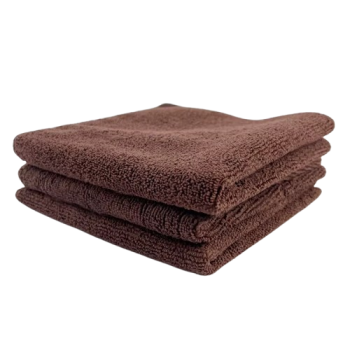 Stack of three brown bath towels folded neatly on top of each other